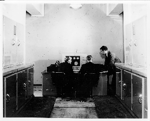 Alan Turing standing beside the Ferranti Mark 1 Console